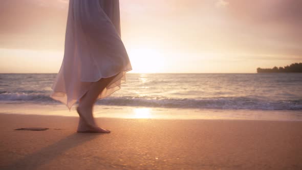 Woman in Beautiful White Dress at Sunset Slow Motion Woman Feet Walking By Beach alt