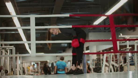 A Young Woman with Long Hair Steps on the Ring and About To Train Her Boxing alt