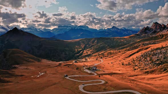 Winding road in Passo Giau and brown Dolomites, aerial view alt