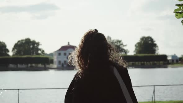 Young Caucasian Woman Tourist Walking in European Park  alt