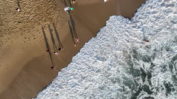 Happy children play on the sea waves alt