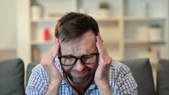 Portrait of Stressed Young Man Having Headache alt