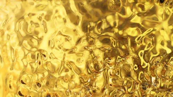 Super Slow Motion Shot of Golden Liquid Luxury Background at 1000Fps alt