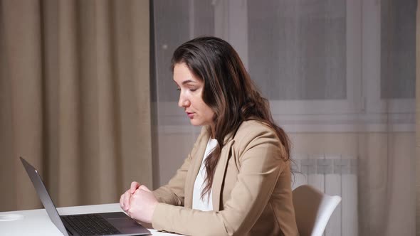 Young Brunette Talks on Video Call and Sighs with a Relief alt