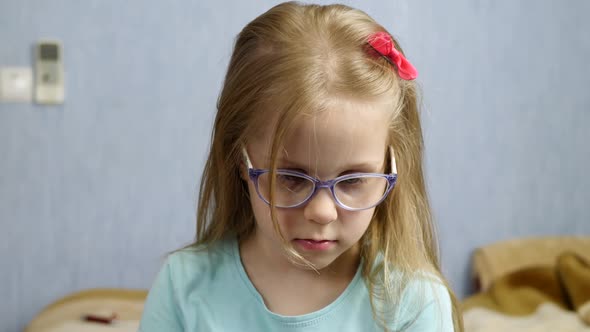 Child Talking on Smartphone with Glasses