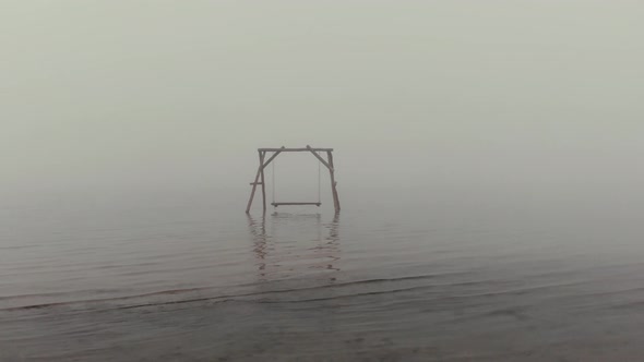 Aerial Motion Above Dry Reed To Empty Swings in Sea Water
