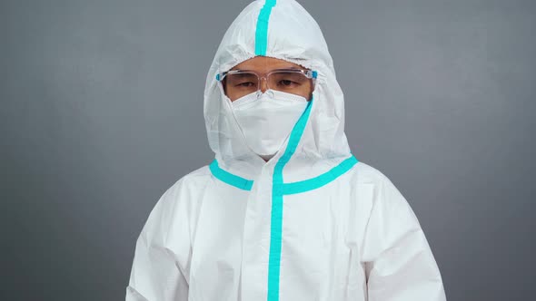 doctor in protective PPE suit wearing face mask and face shield protection from coronavirus