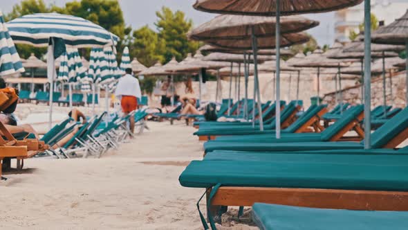 Empty Sun Loungers on the Sandy Beach Against the Turquoise Sea Albania Ksamil alt