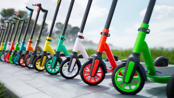 Countless colourful electric scooters standing in a row on a sunny day. 4KHD alt
