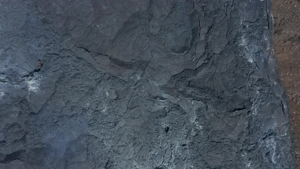 Aerial Birds Eye Overhead Top Down View of Black Lava River in Fagradalsfjall Iceland Dolly in Day alt