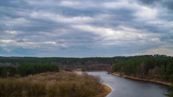 Spring landscape with river and storm clouds, time lapse alt