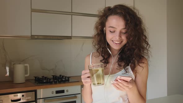 The Woman is Listening to Music and Smiling alt