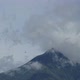 Clouds moving from the wind near the top of a volcano, timelapse. Blue sky on sunny day - VideoHive Item for Sale