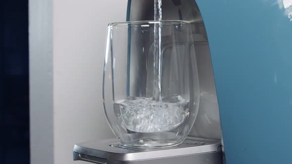 Slow motion of a water cup filling in a water filtering machine alt