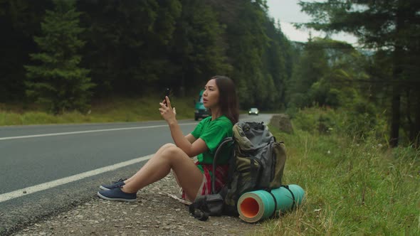 Worried Pretty Asian Female Tourist Trying to Catch Cellular Connection During Mountain Hiking alt