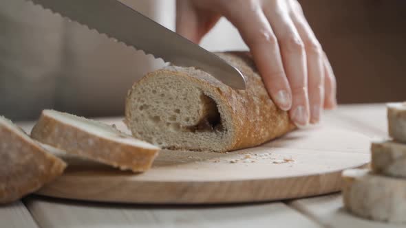 A Baker Cuts Fresh Aromatic Crispy Bread Closeup