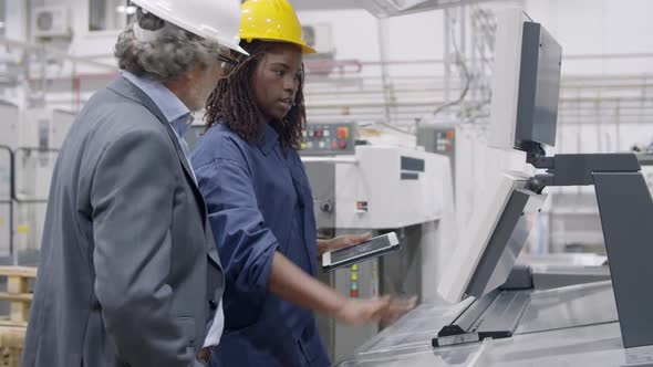 Black Female Factory Engineer Showing New Machines alt