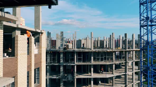 Bricks and Concrete Building Is Being Constructed alt