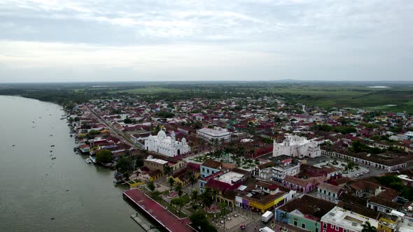 rotational drone shot of the main church and the papaloapan river in tlacotalpan, veracruz, mexico alt