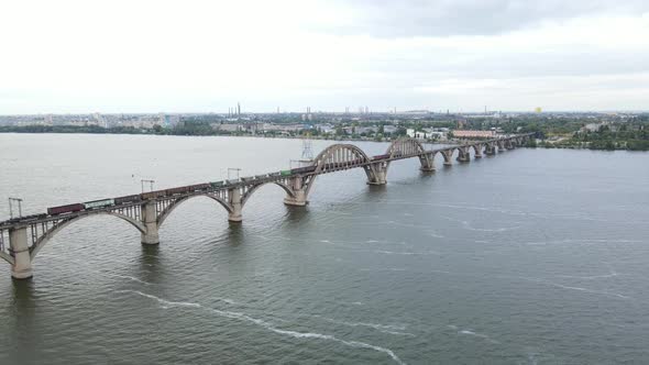 Aerial View of a Train Crossing a Beautiful Bridge