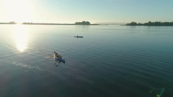 Aerial Drone Footage. Tourists Are Kayaking. Beautiful Sunrise Over River