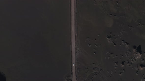 Aerial view of a car driving a desert road, Sainte Rose, Reunion. alt