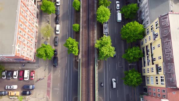 Camera tracks cars and streetcar, ends with a panorama of the TV tower Great aerial view flight tilt alt