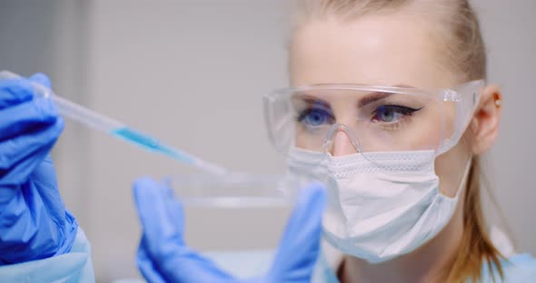 Working in Laboratory - Scientist Using Pipette in Lab alt