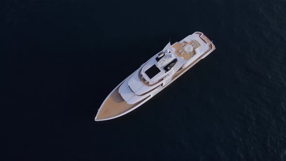 Private luxury yacht at the anchorage, top aerial view.