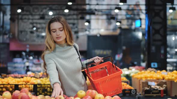 Young Business Woman Girl Buyer Client Blonde Lady Consumer Stands in Shop Near Counter with Fruits alt