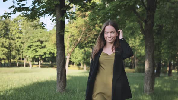A Beautiful Girl Walks in the City Park alt