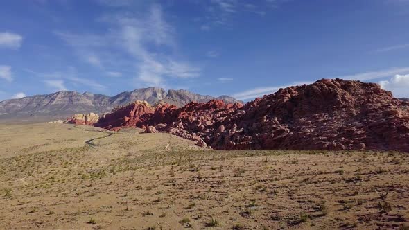 Aerial drone view over desert towards sandstone mountains, in Red rock, Arizona alt