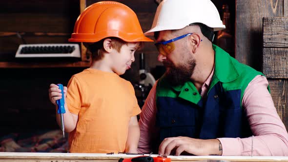 Child Learning Use Tools with Dad. Parent in Protective Helmet Teaching Little Son To Use Different alt