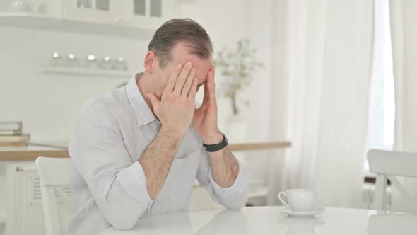 Stressed Middle Aged Man Getting Worried at Home alt