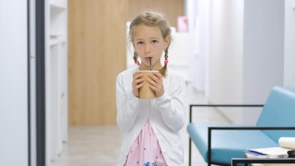 Little Girl Drinks Cacao or Hot Chocolate alt