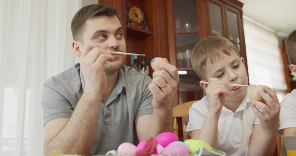 Dad and His Son Paint Easter Eggs alt