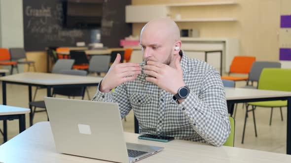 Teacher Who Teaches Online Lessons Sits in Front of the Computer alt