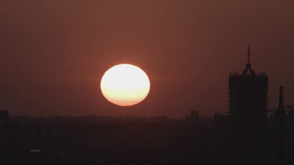 Beautiful timelapse of a sunset over city buildings 4K