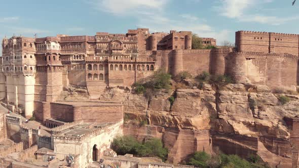 View of the majestic Mehrangarh Fort's facades and exterior walls surrounded by birds of prey, India alt