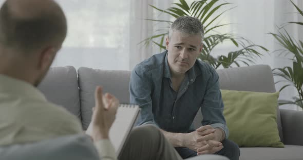 Man having a therapy session with a professional psychologist