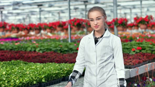 Happy Female Agricultural Engineer in Uniform Posing at Modern Greenhouse Medium Shot alt