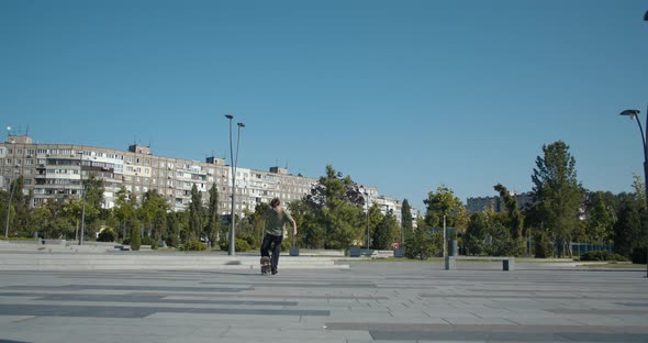 Quick Stop with a Turn By a Skater in a T-shirt, Sunny Day at the Skatepark,  alt
