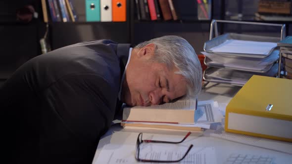 He falls asleep at the executive desk alt