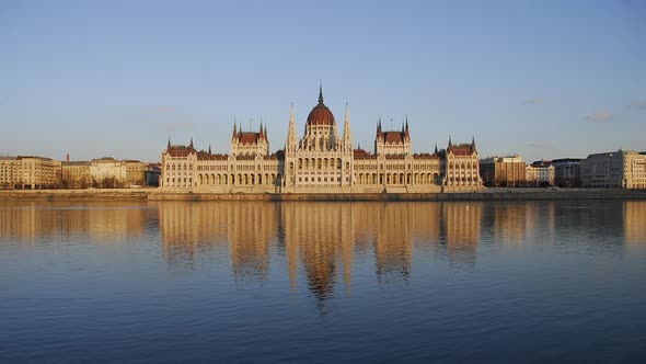 Hungarian Parliament in Budapest on Danube River. Timelapse day to night