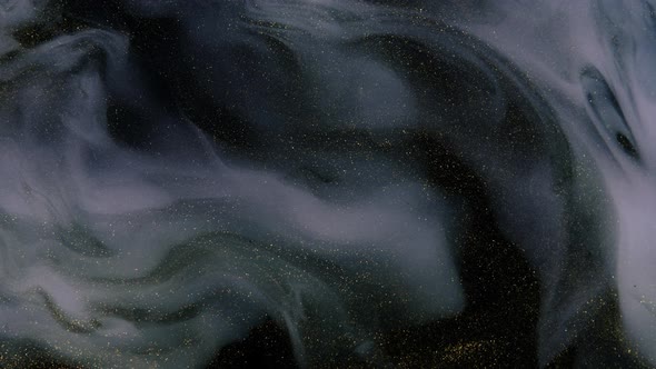 Beautiful Golden Shimmering Particles in White Smoke on a Black Background alt