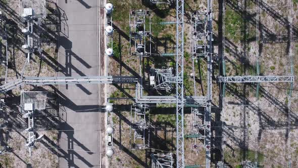 Aerial view of electrical power transformer in high voltage substation. alt