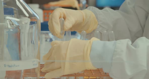 Scientist working in a pharmaceutical laboratory conducting experiments alt