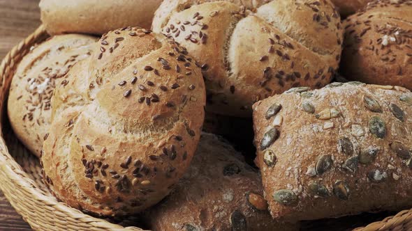 Wicker basket with selection of breads and pastries. Assortment of baked products 