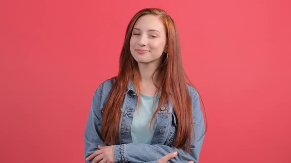 Pretty Girl Looking at Camera with a Smile Isolated Over Red Background alt