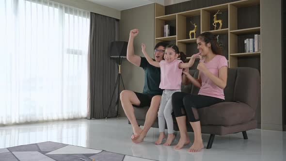 A family holiday where parents and children happily sit and watch sporting events alt